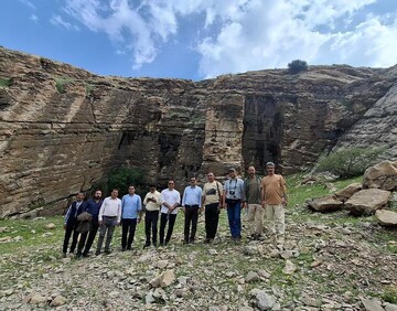 Members of an archaeological team pose for a photo near a recently discovered ancient quarry, which is believed to be once a source for giant stones used for the construction of Achaemenid palaces in Susa, western Iran, April 11, 2015.